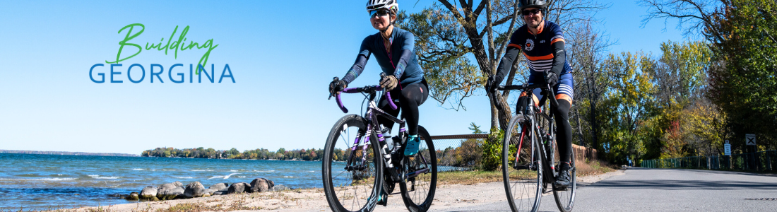 two people riding bicycles with words Building Georgina